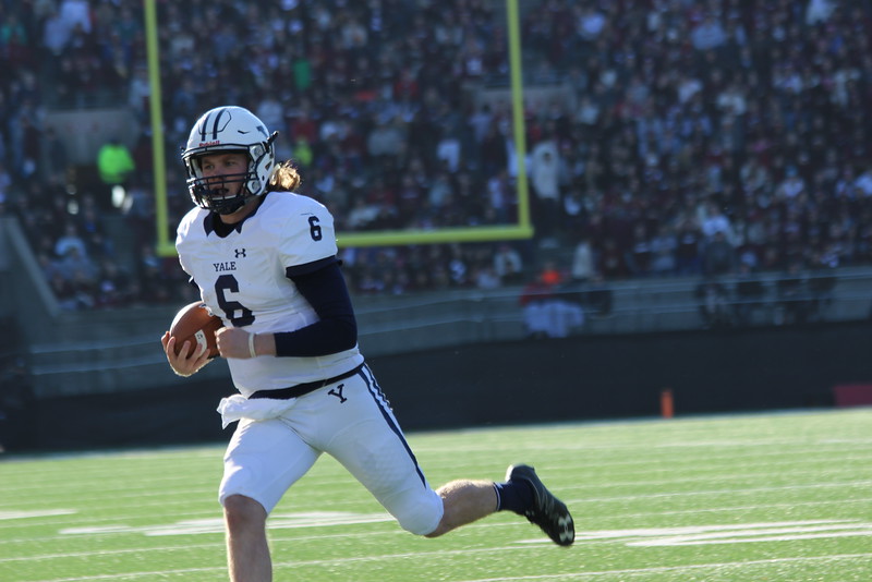 Sophomore quarterback Kurt Rawlings sprints out-of-bounds against the Crimson. The then-freshman threw for 131 yards and two touchdowns in last year's rendition of The Game.