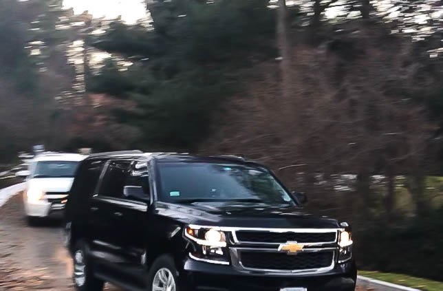 Two SUVs leave the property of Overseer and committee member Tracy P. Palandjian ’93. Members of the committee searching for Harvard’s next president convened secretly at Palandjian's Belmont, Mass. home Saturday.