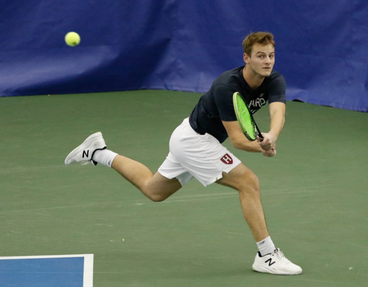 Junior Christopher Morrow returns a cross-court backhand in his doubles match with partner senior Grant Solomon.