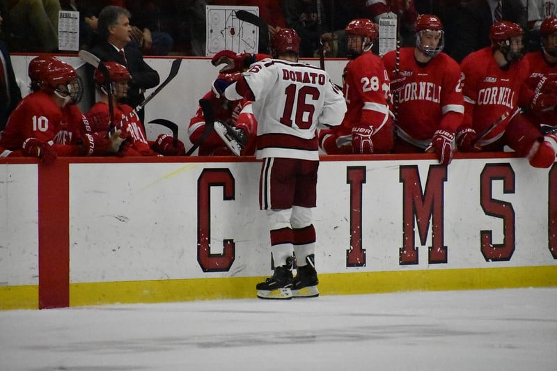 Harvard's Ryan Donato gives a not-so-friendly helping hand to a Cornell opponent on a line change.