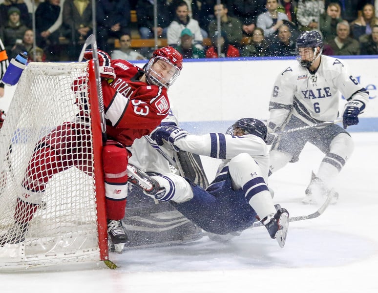 Jack Badini crashes the Yale net during the Crimson's regular season closeout in New Haven.