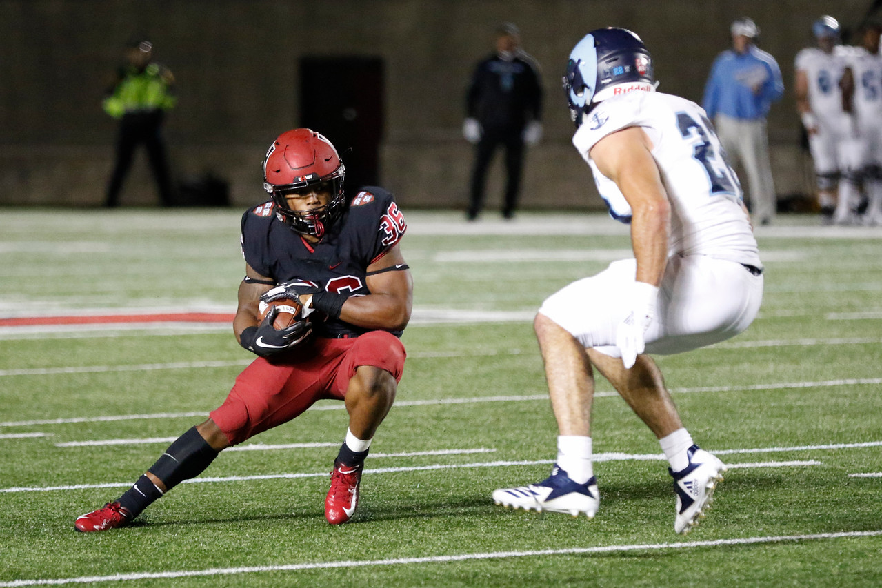 Sophomore running back Devin Darrington jukes out a Rhode Island defender.