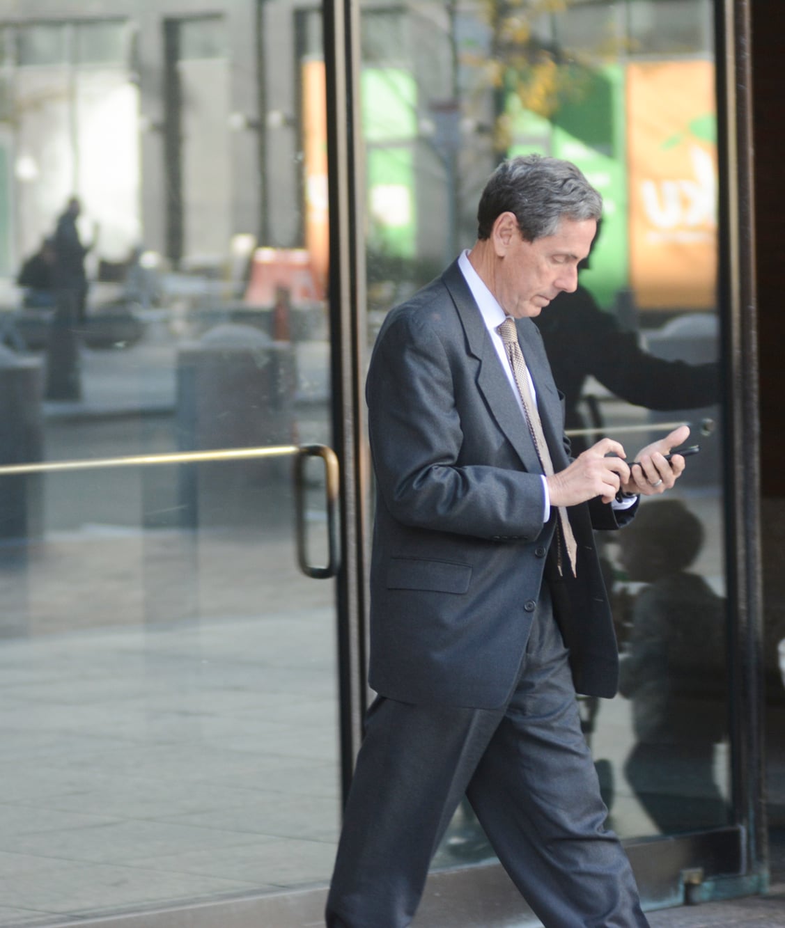 Students for Fair Admissions President Edward Blum checks his phone outside the courthouse on the third day of the Harvard admissions trial.