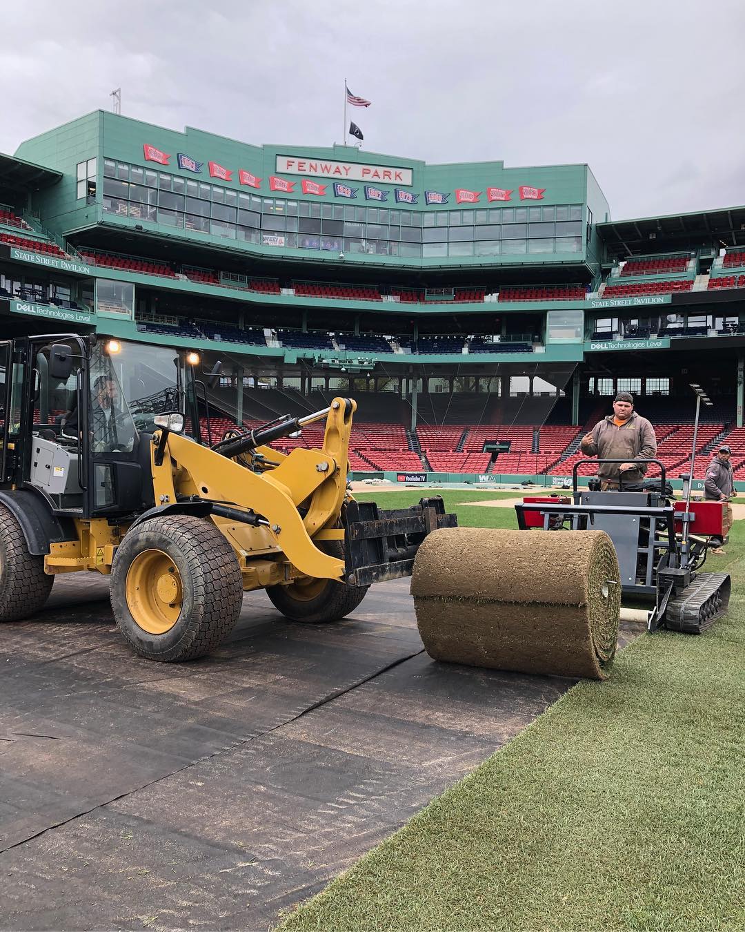 Sod is installed over the clay infield to provide an even playing surface.