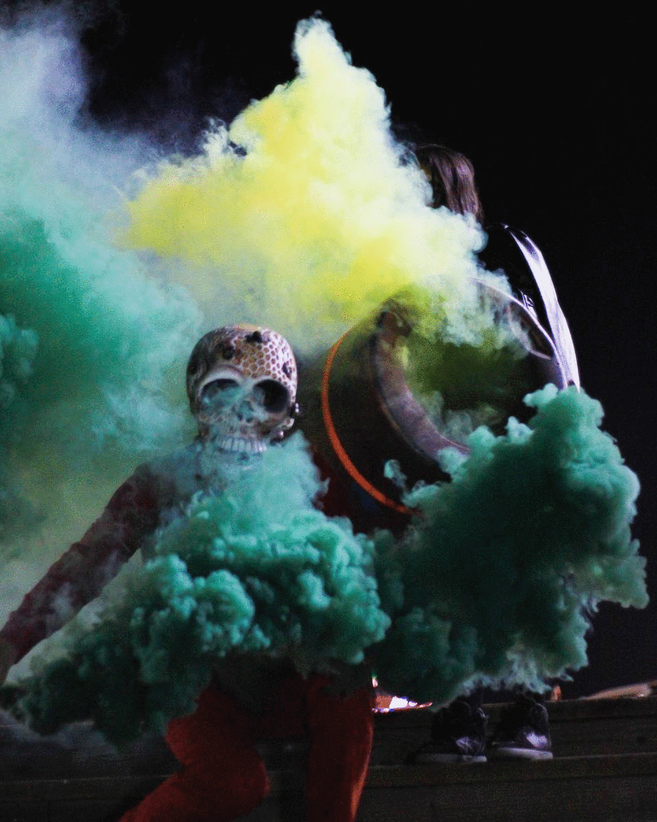 Green clouds pour from Butch's smoke grenades at the Santa Monica Pier.