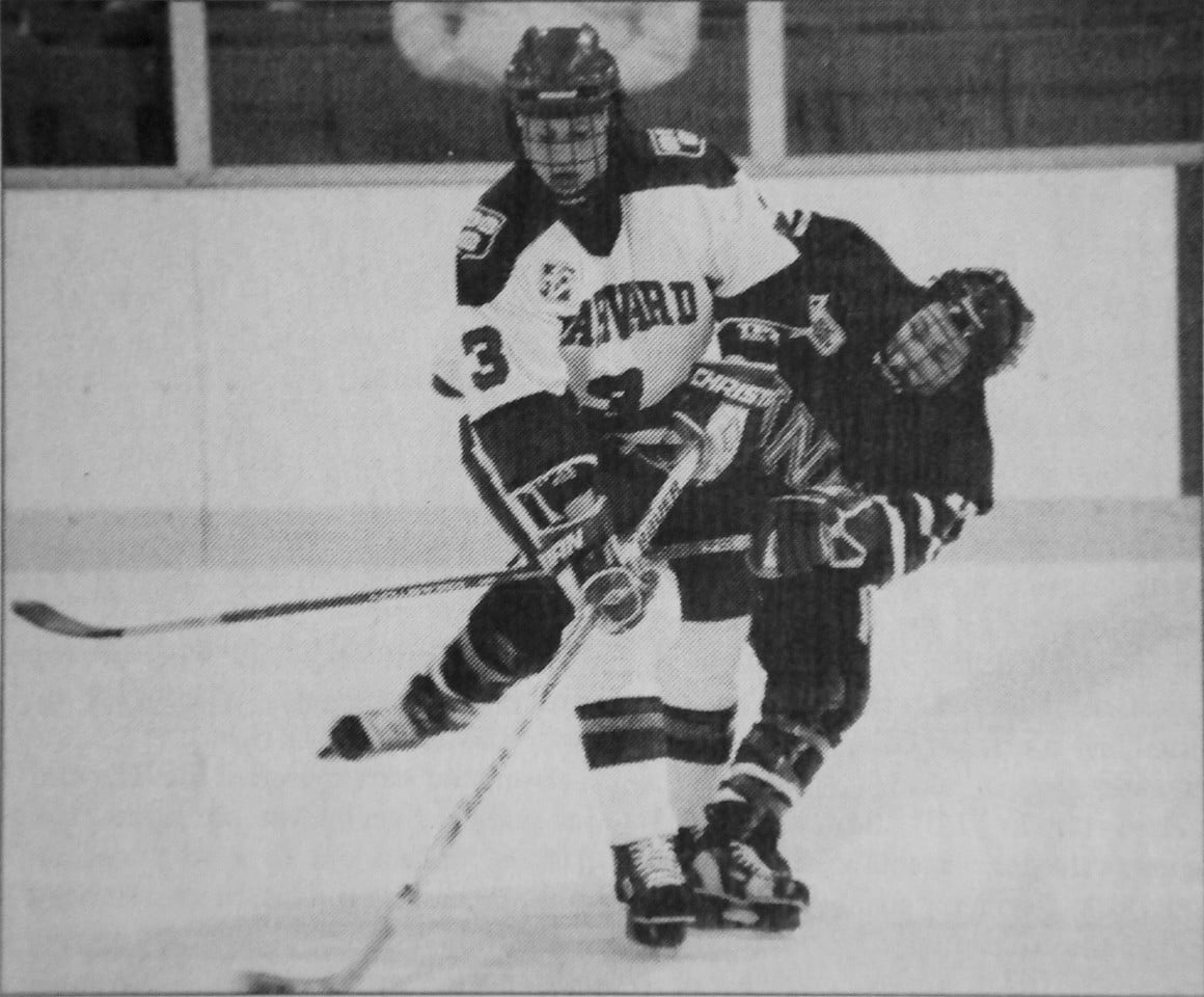 Defenseman Angela Ruggiero smoothly evades an attempted steal from a opposing player.