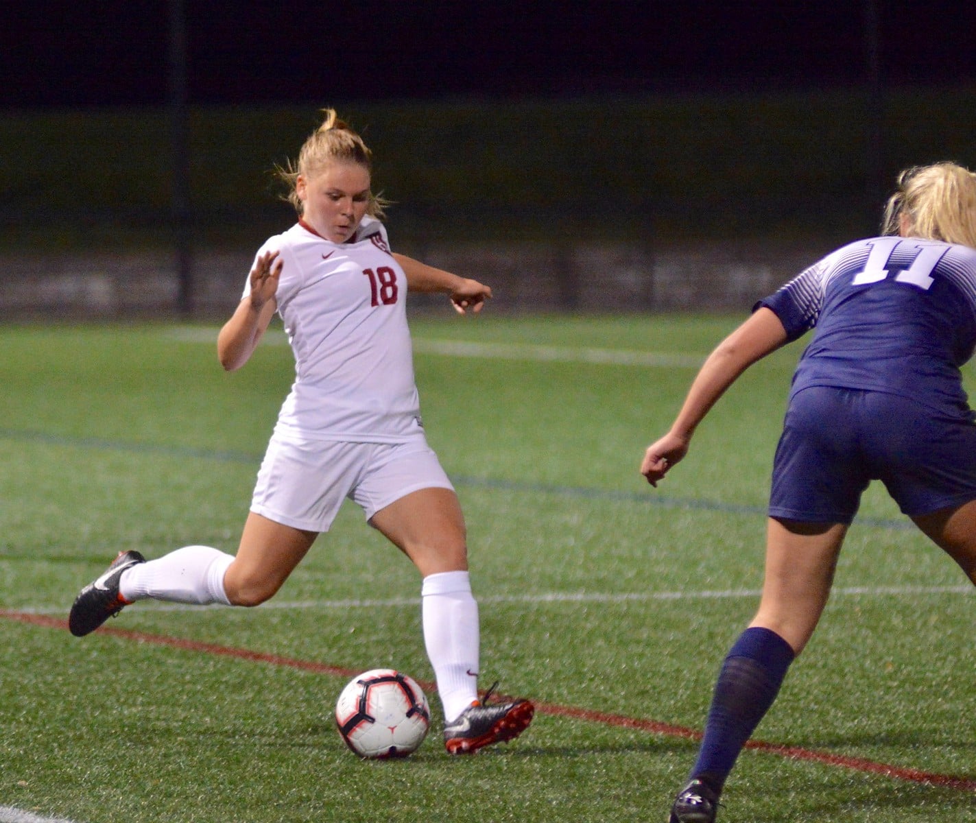 Sophomore defender Lara Schenk looks to find a teammate as she is pursued by an opposing striker. The Seelze, Germany native helped Harvard to its first clean sheet of the season as it cruised past Quinnipiac 3-0 on Wednesday.