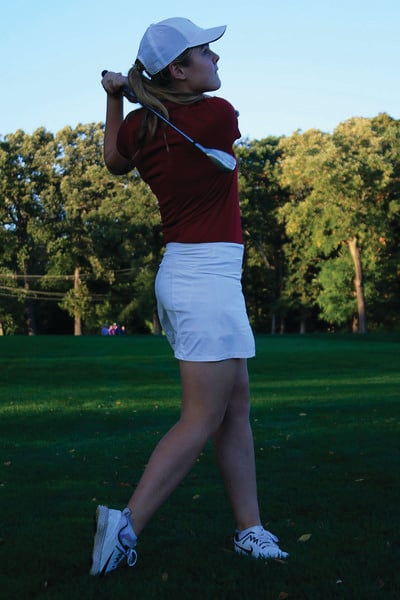 Sophomore Chloe Royston finishes a shot from the fairway.