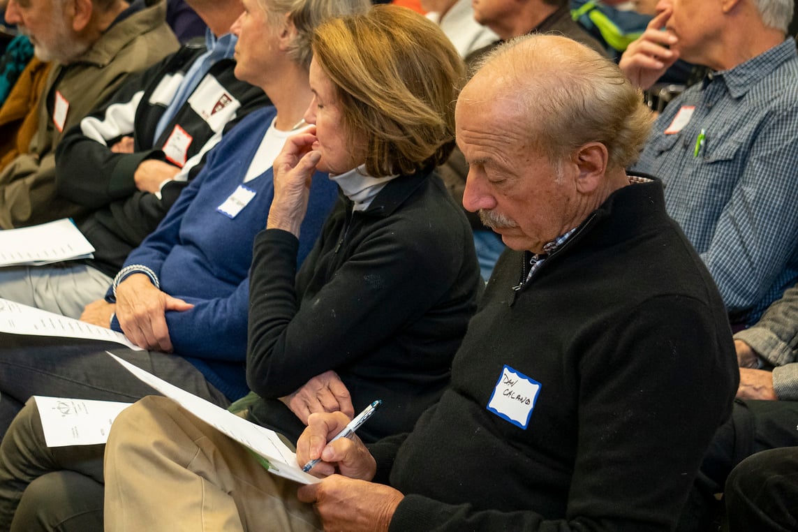A member of the audience takes notes as City Council candidates speak at the Cambridge Citizens Coalition open forum.