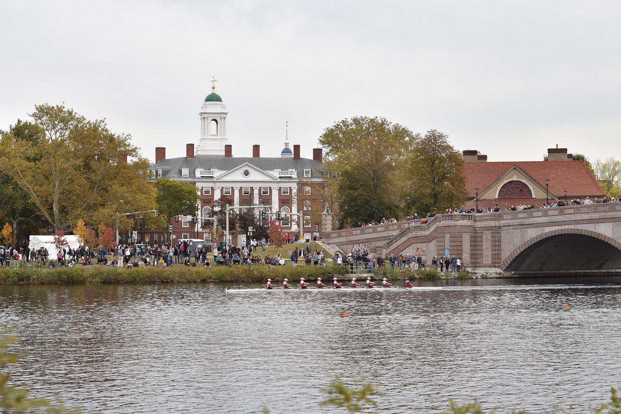 Thousands of spectators line the banks of the Charles River as boats pass by the Anderson Memorial Bridge in the Head of the Charles Regatta