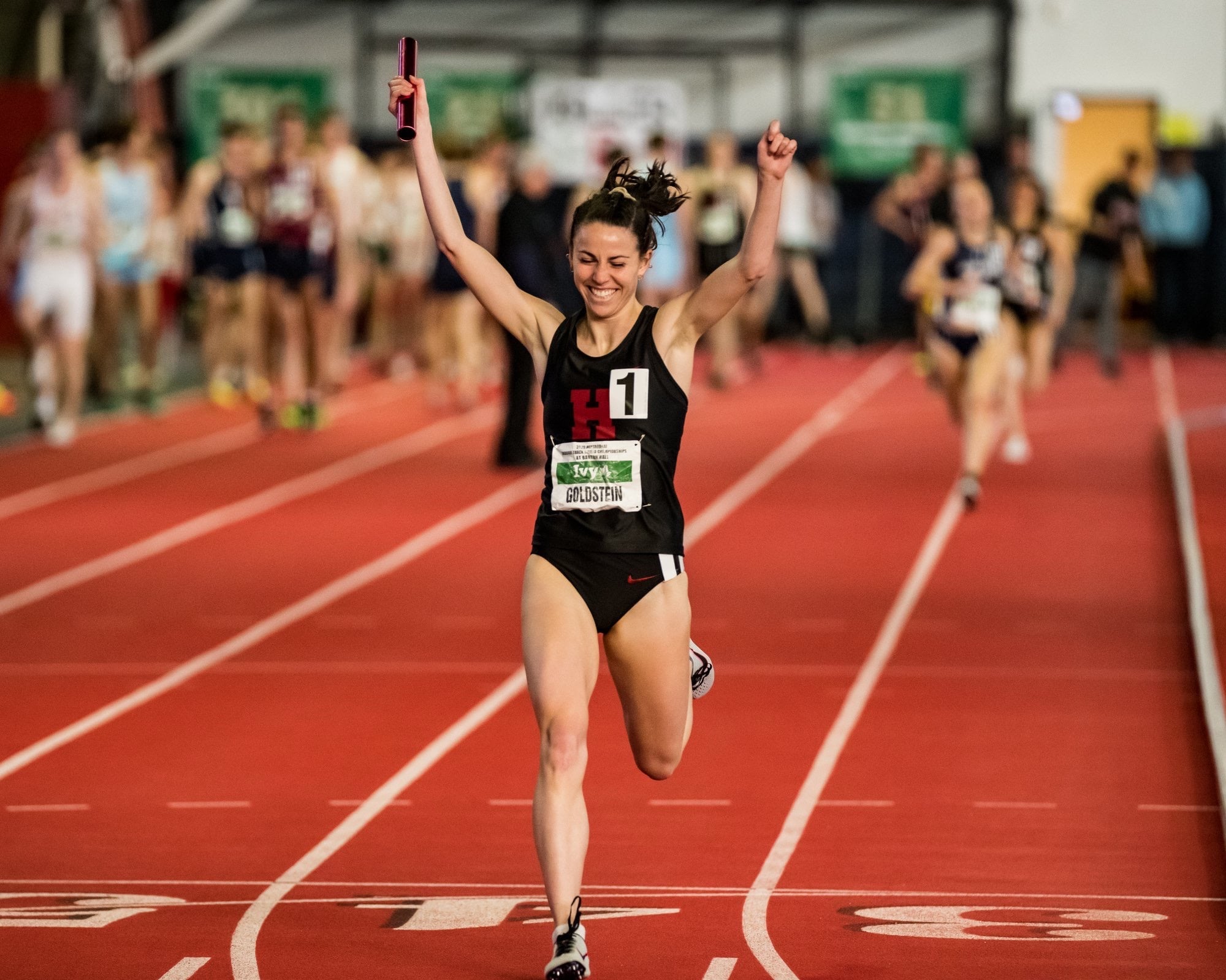 Junior distance runner Abbe Goldstein crosses the relay finish line with a comfortable margin, showing the speed that helped her qualify for NCAA Indoor Track and Field Championships.