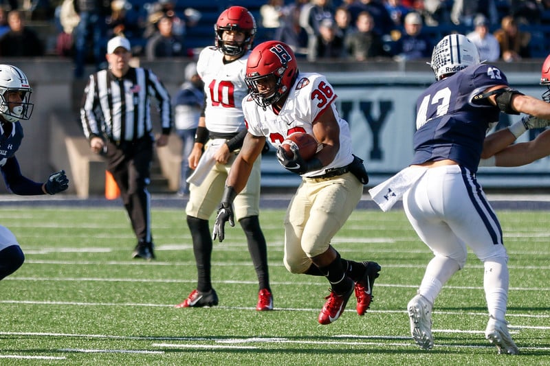 Senior running back Devin Darrington, pictured above in his final game in a Harvard uniform, announced his transfer to the University of Virginia.