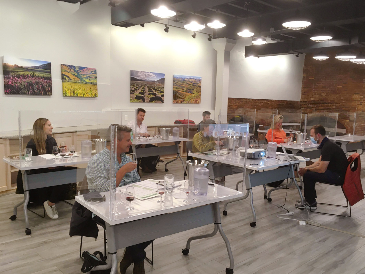 Students participate in a class at Commonwealth Wine School, which opened for in-person classes this month at the Garage in Harvard Square.