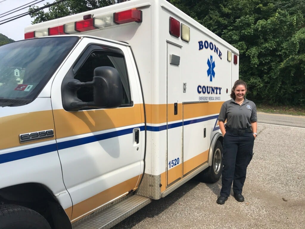 Jessica P. Miller '21 stands with her ambulance.