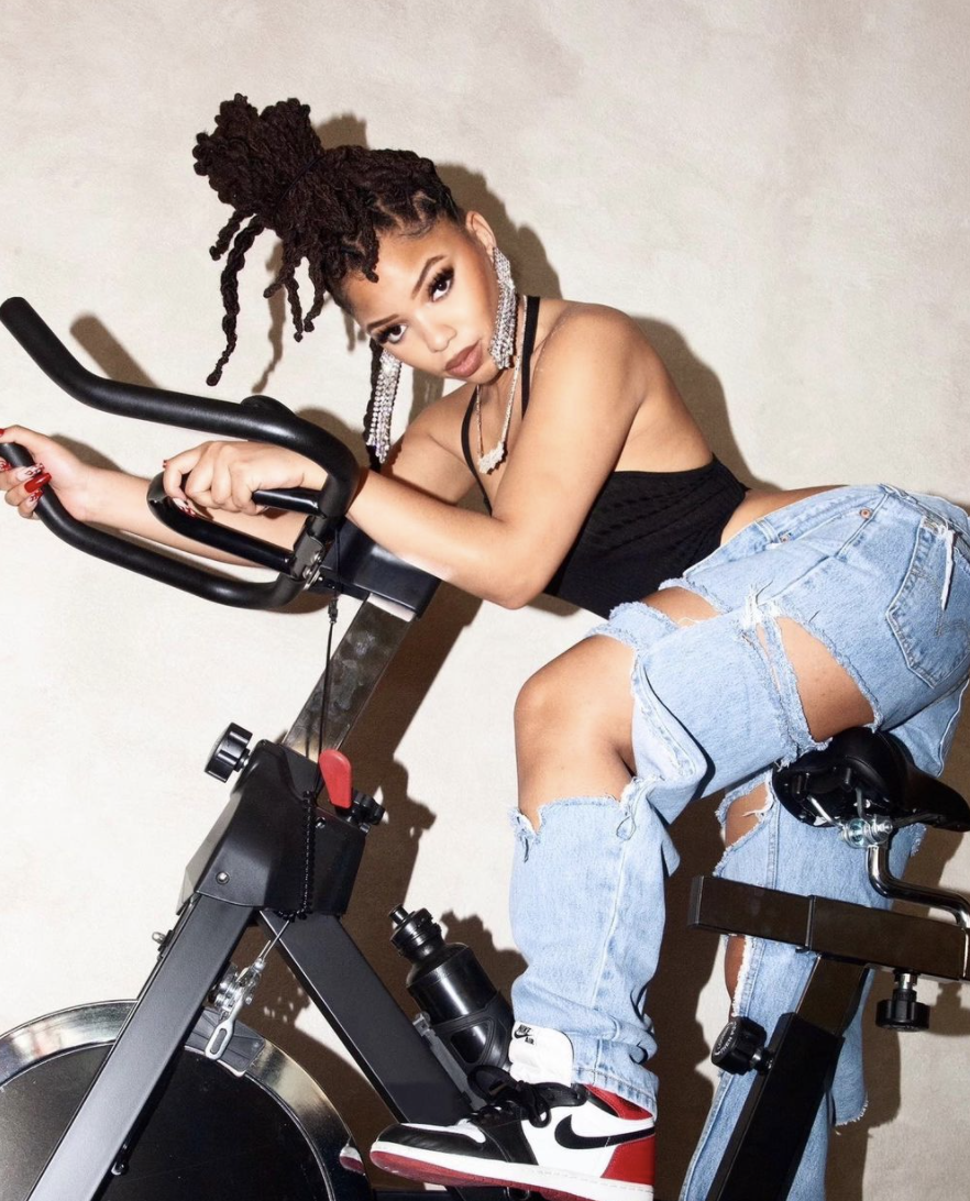 Chloe Bailey rides a stationary bike in an Instagram post.