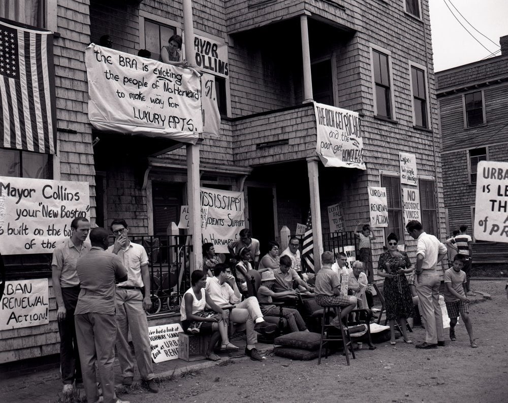 Residents of Barry’s Corner congregate with banners and signs in protest of the Boston Redevelopment Authority’s plans to demolish their homes.