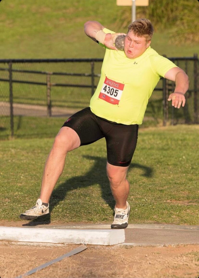 The determination is evident in Alexander Kolesnikoff's face as he prepares to uncork the 16-pound iron shot put.