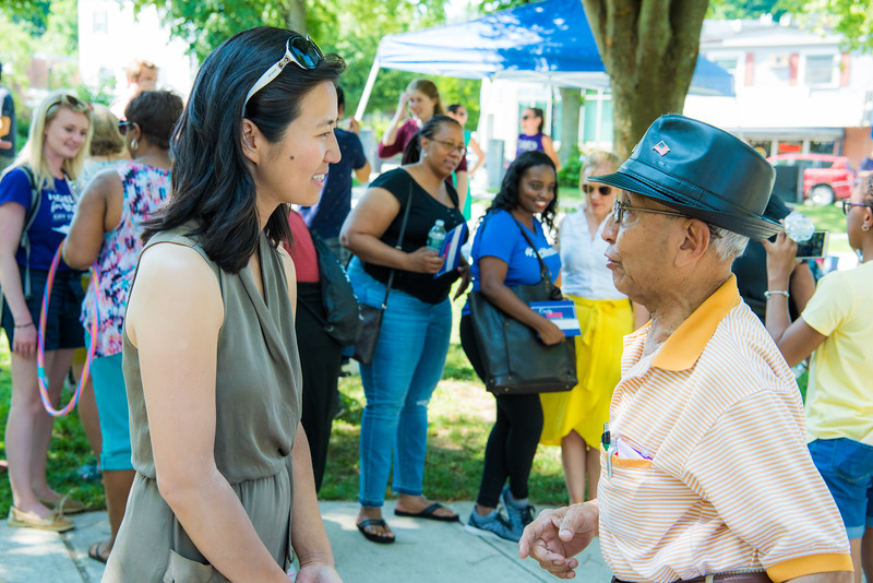 Wu talks to community members at a Roslindale ice cream social in 2019.