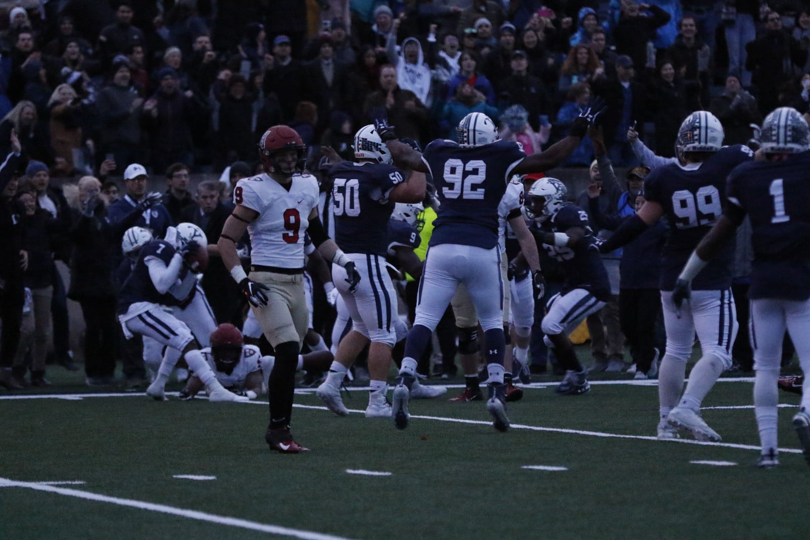 Yale celebrated an instant classic over Harvard under the cover of darkness, the lack of light perhaps signaling the lost season to come.