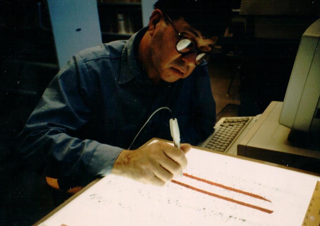 Richard C. Lewontin ’50 — a prolific scientist who developed new methods for analyzing genetic variance — in the lab, manually scoring a DNA sequence.