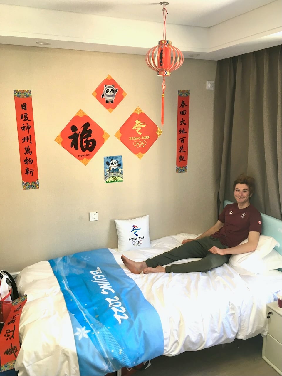 Drolet relaxes in his room in the Olympic Village. He took a year off from Harvard to focus on skiing full-time, but plans to return in the fall to complete his degree in Physics.