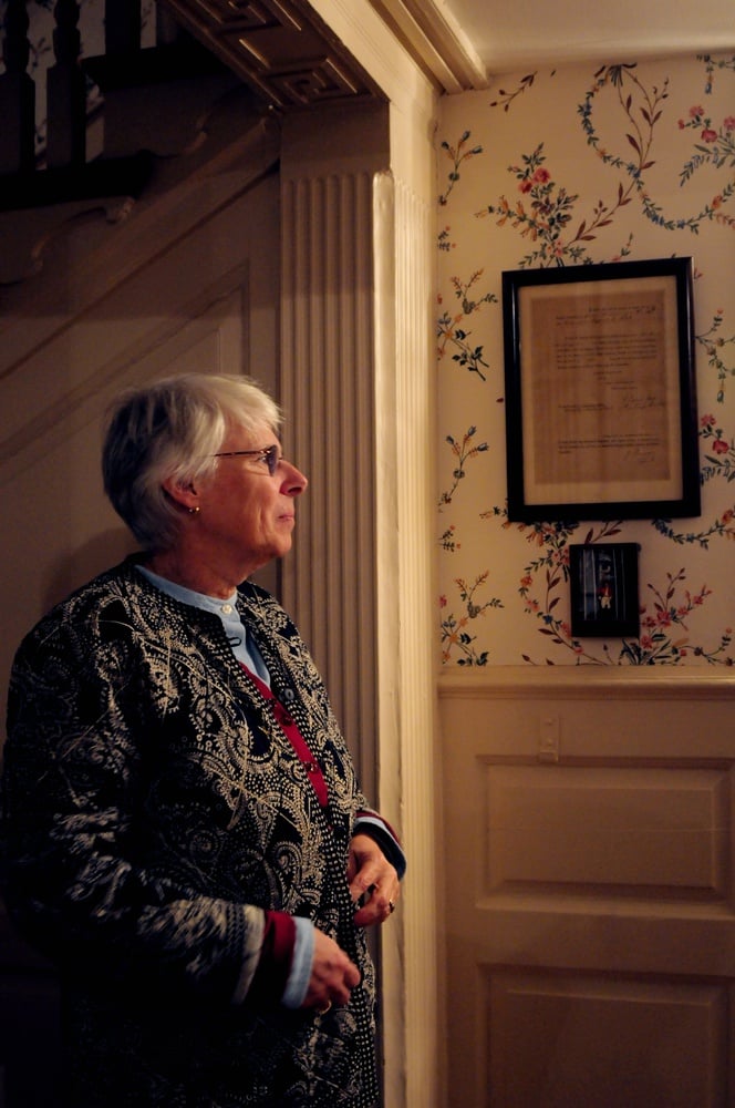 Judith S. “Judy” Palfrey ’67 pictured in Apthorp House in 2014. Palfrey wrote they were still waiting for several reports to finish before making further decisions about the fireplace.