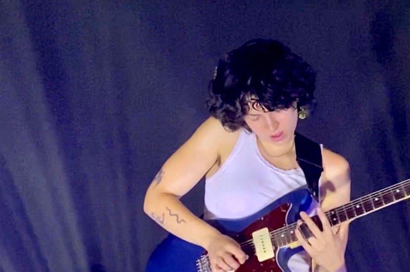 Maskin shreds on her guitar.