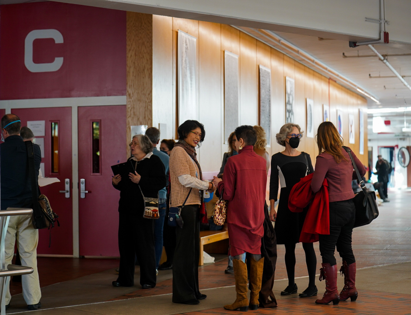 Harvard professors file into Science Center Hall C for the first in-person faculty meeting since Covid-19 in fall 2022.
