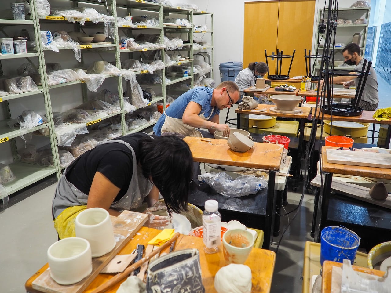 Students work on pottery wheels at the Harvard Ceramics Program's studio in Allston.