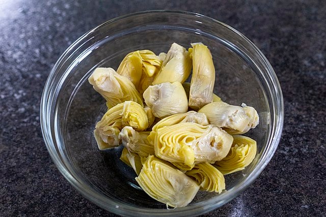 Marinated artichoke hearts in a bowl.