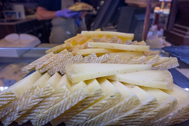 Queso manchego is traditionally served cut into thin triangular wedges.