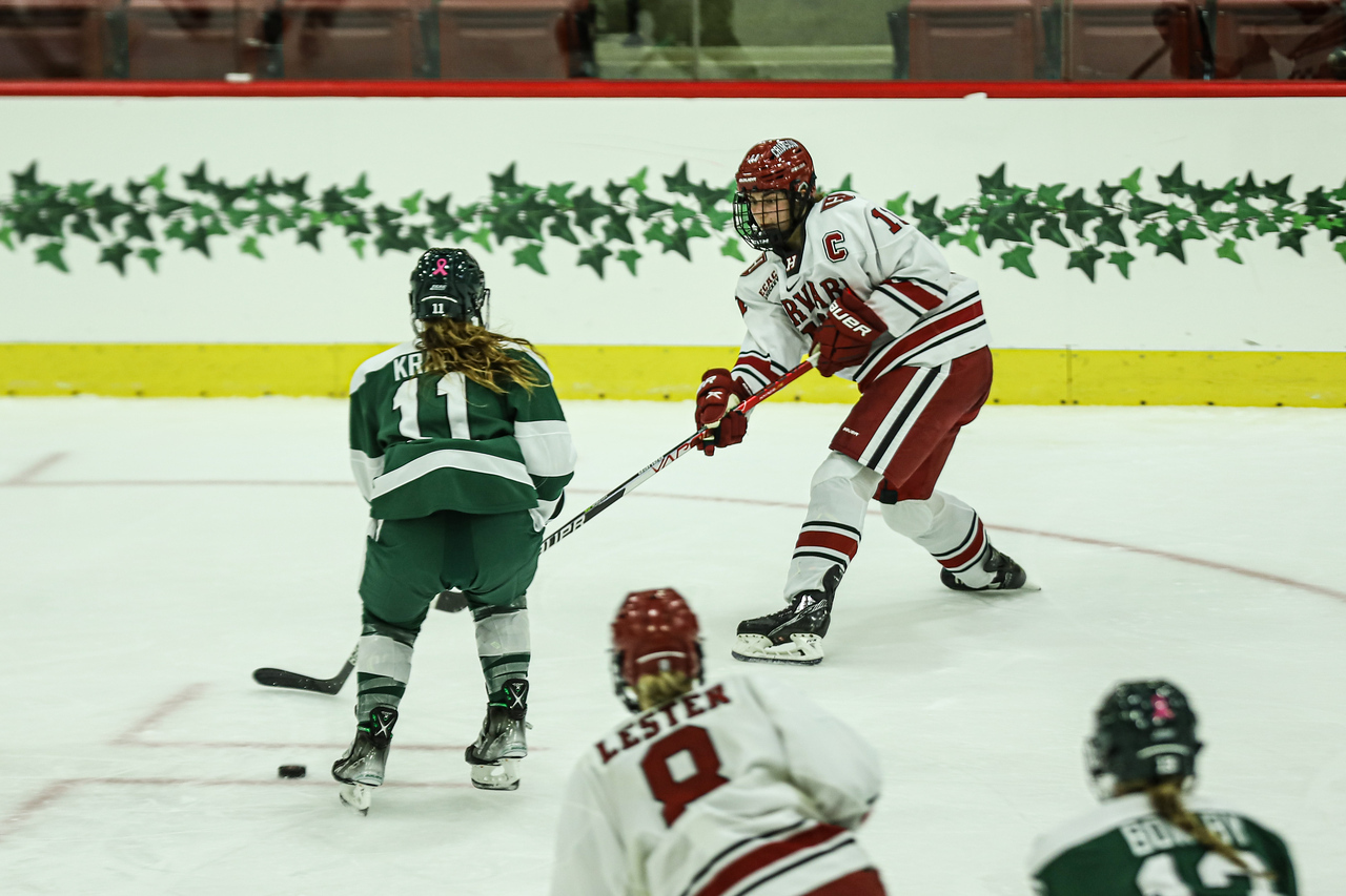 Senior forward Kristin Della Rovere passes to sophomore forward Paige Lester in an October game against Dartmouth. The Crimson eventually defeated the Big Green in a 3-0 shutout.
