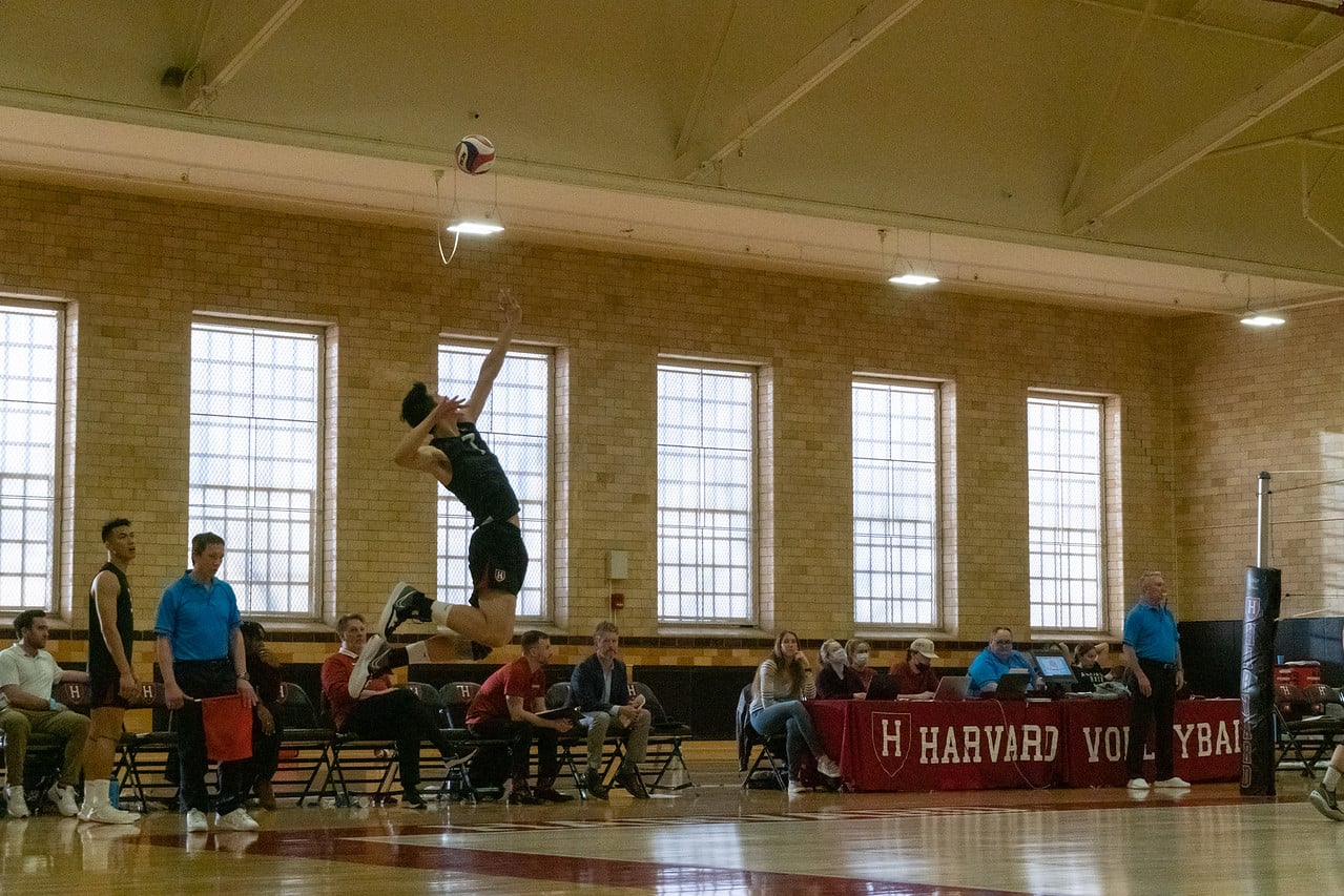 Former outside hitter Eric Li '22 jumps up to serve and pummel the ball over the net in the Crimson's 2022 game against Charleston. Harvard went on to lose both matches against the South Carolina team, and will next face them this year on February 17 and 18.