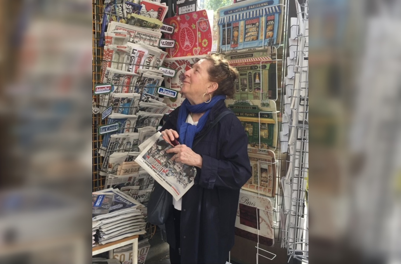 Maxine Gordon surrounded by newspapers.