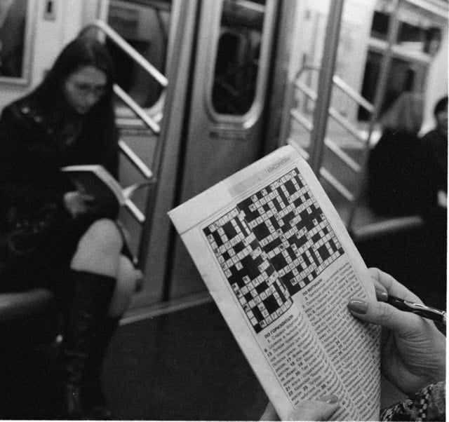 A person works on a crossword puzzle in the subway in New York City, 2008.
