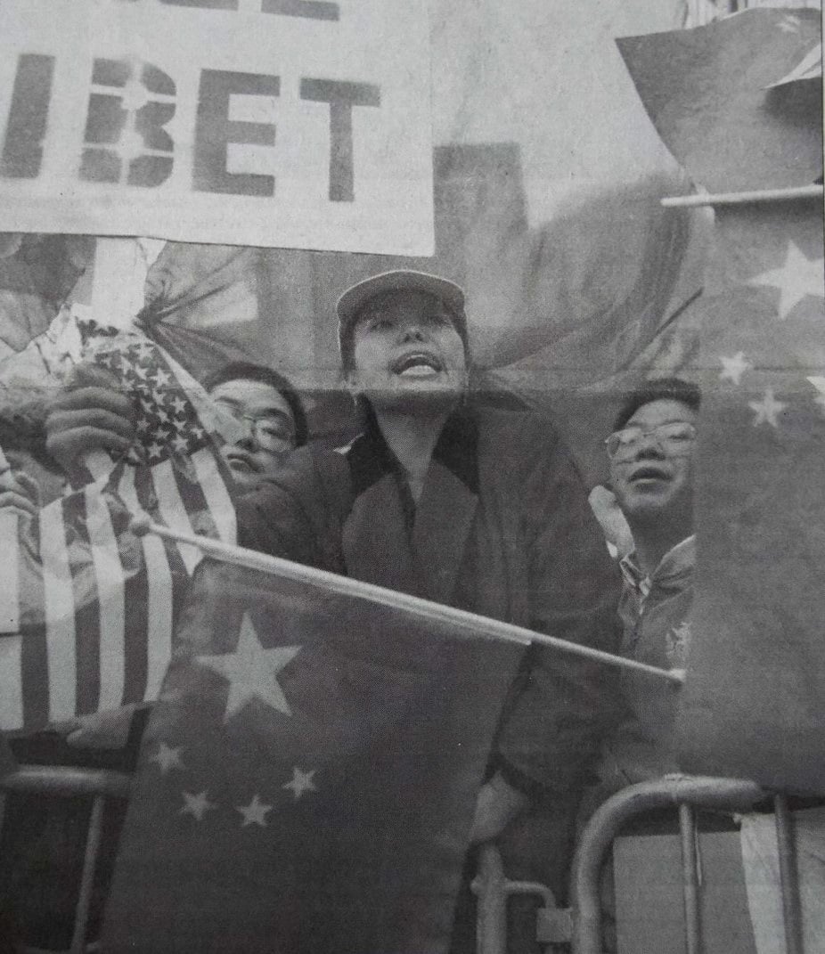 Protesters waving U.S. and Chinese flags flanked both sides of Jiang's pathway to Sanders Theatre.