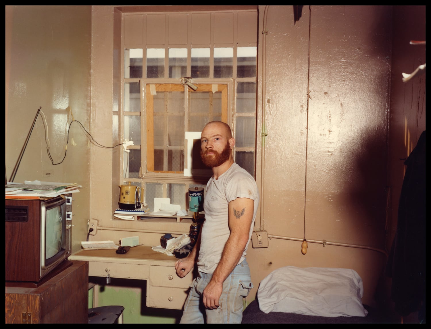 A man incarcerated at Walpole stands in his cell in the early 80s. Each of the prison's 10 cell blocks had 40 cells.