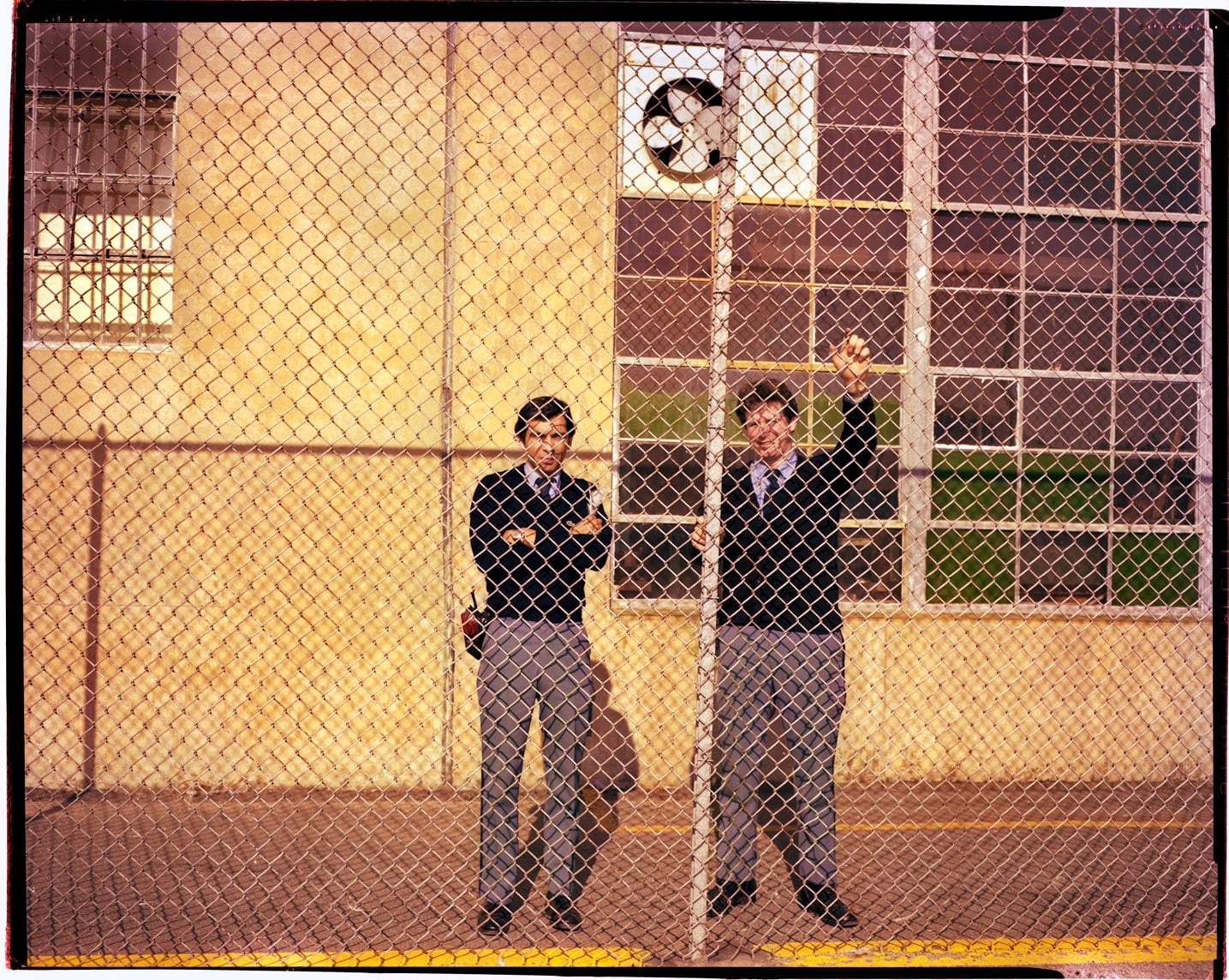 Corrections officer stand behind a fence at Walpole in the 1980s.
