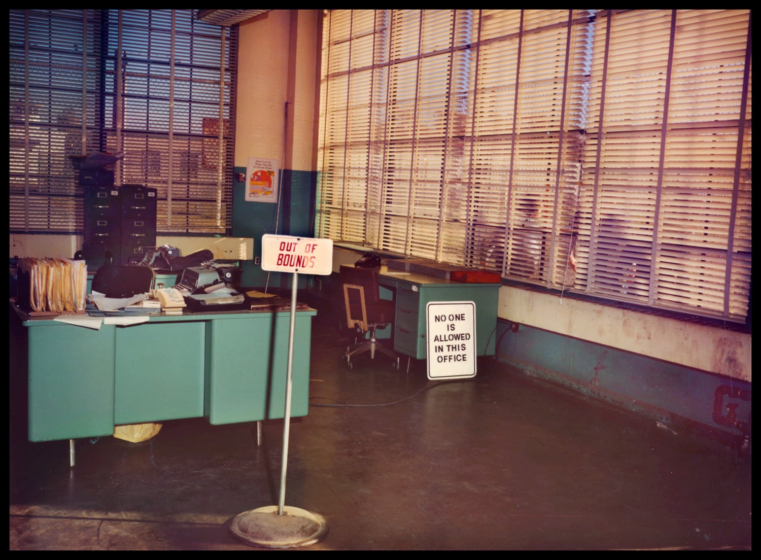 A sign in an office at Walpole Prison reads "No one is allowed in this office."