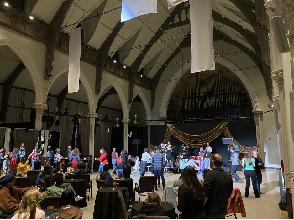 Attendees celebrate at the 14th Annual Dance for World Community Festival's dance party in the Sanctuary Theatre on September 23, 2023.