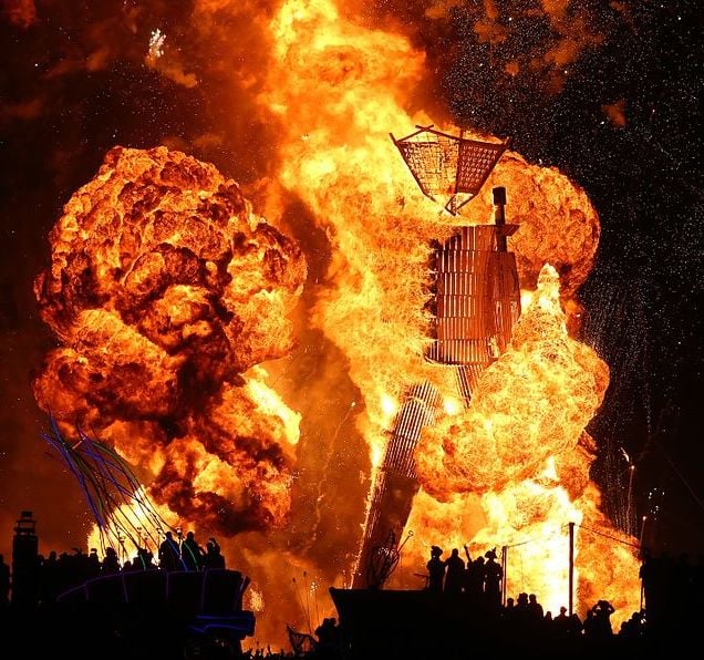 The Man begins burning at Burning Man in 2014.