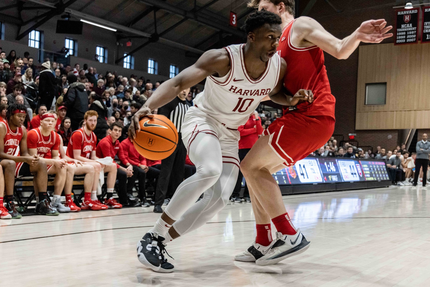 Then-first-year forward Chisom Okpara dribbles the ball past Cornell in Harvard's 95-89 takedown of the Big Red on Jan. 21, 2023. Okpara had the fourth-highest average of points scored last season at 7.4.