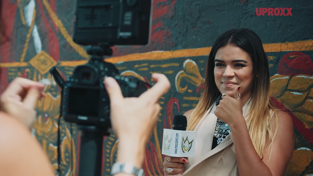 Artist Karol G being photographed in 2016.