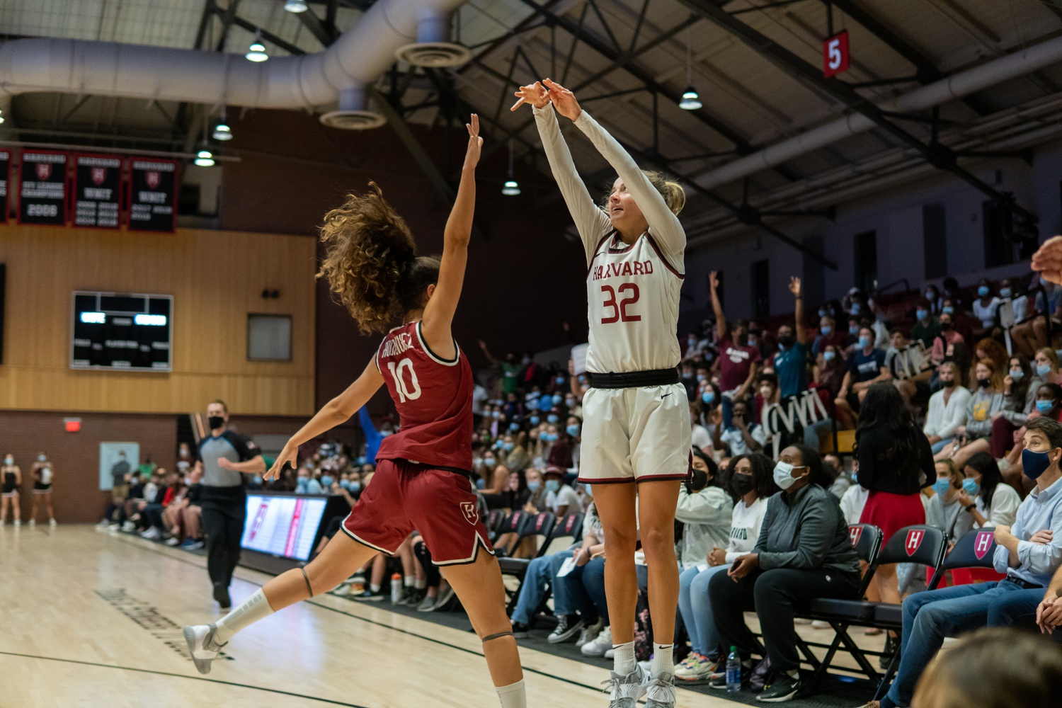 Then-first-year guard Elle Stauffer attempts a three-pointer against then-first-year guard Elena Rodriguez in Harvard’s annual Crimson Madness game on Oct. 15, 2021.