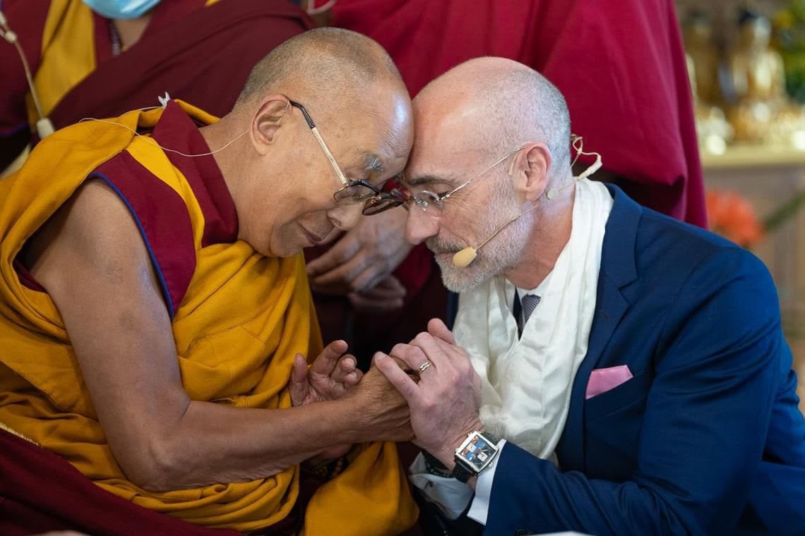 Arthur C. Brooks and the Dalai Lama share an embrace during a trip to Dharamsala, India last week.