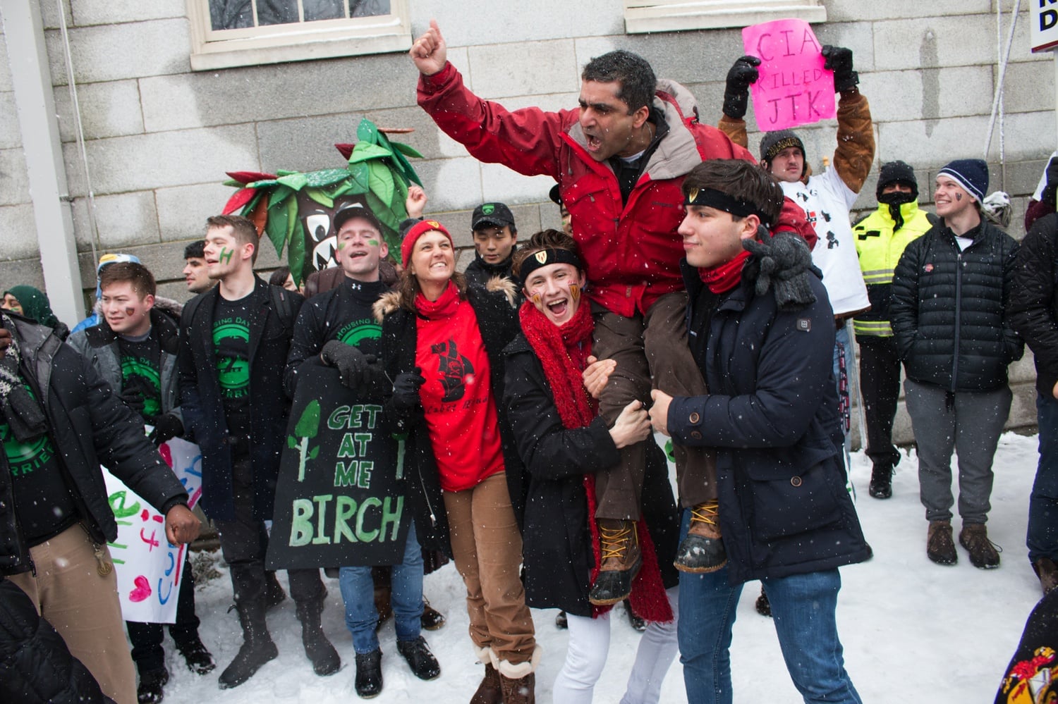 Two students hoist Khurana on their shoulders during a snowy Housing Day in 2015.