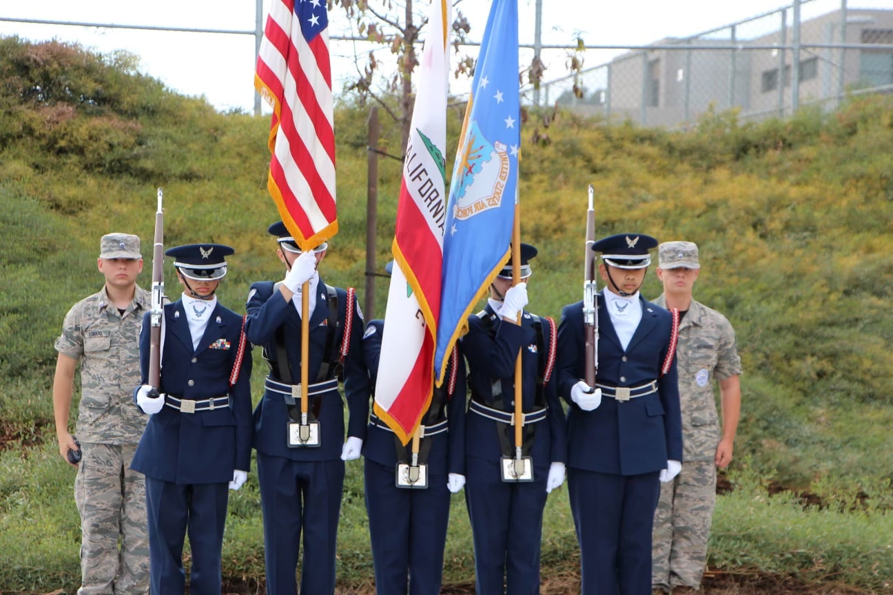 The writer, with her Air Force Junior Reserve Officer Training Corps cohort, presenting the colors at a high school football game.